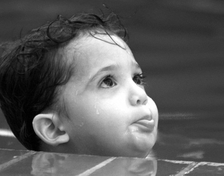 A cute kid taking a swim